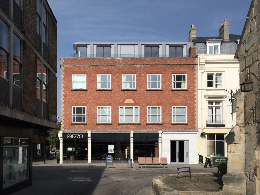 The extensive remodelling, extension and conversion of an existing office building into 18 apartments.