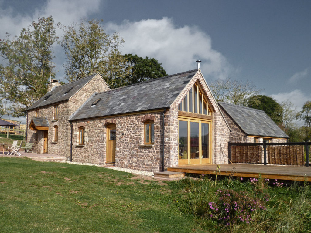 The addition of substantial extensions with contemporary interiors to a traditional stone farm cottage set in rolling countryside.