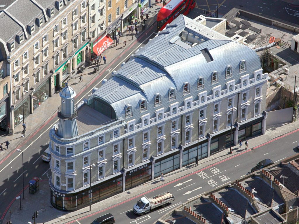 The change of use and reconstruction behind the existing façade of a Grade II landmark building in London's Kings Cross providing office and retail use, with a new floor of offices under a stepping vaulted zinc roof. The building is built directly on two underground train tunnels, creating significant design and construction challenges.